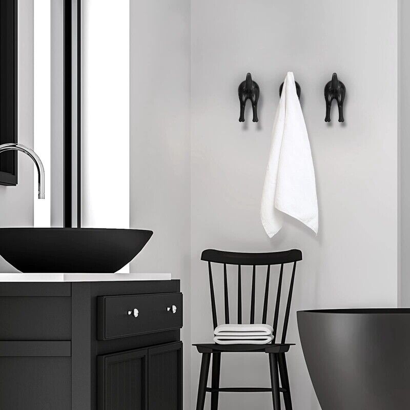 black dog tail wall hooks on wall with towels